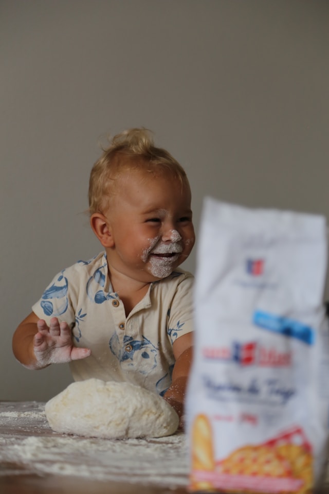 baby working with flour