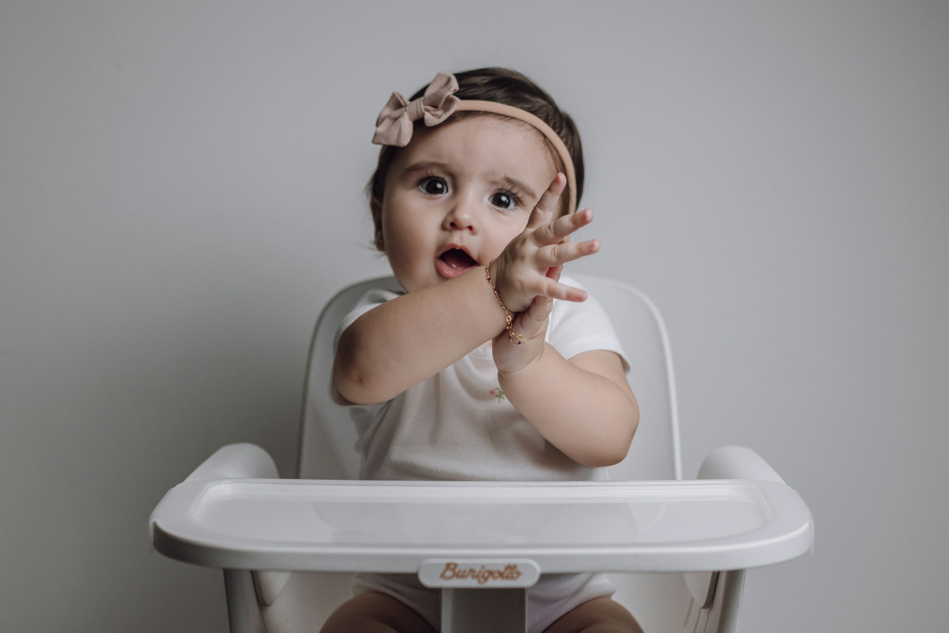 baby girl making a hand sign