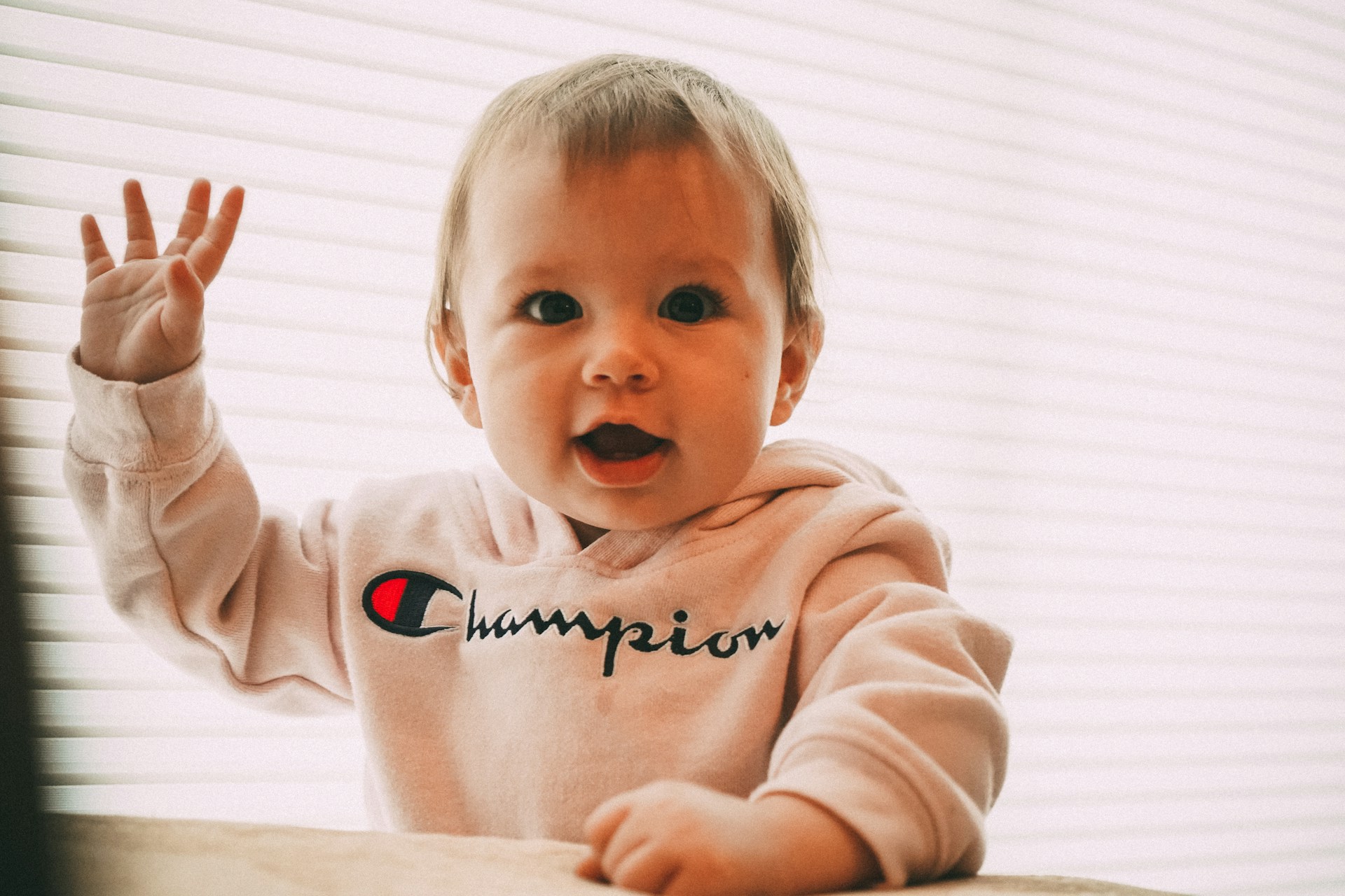baby making a hand sign