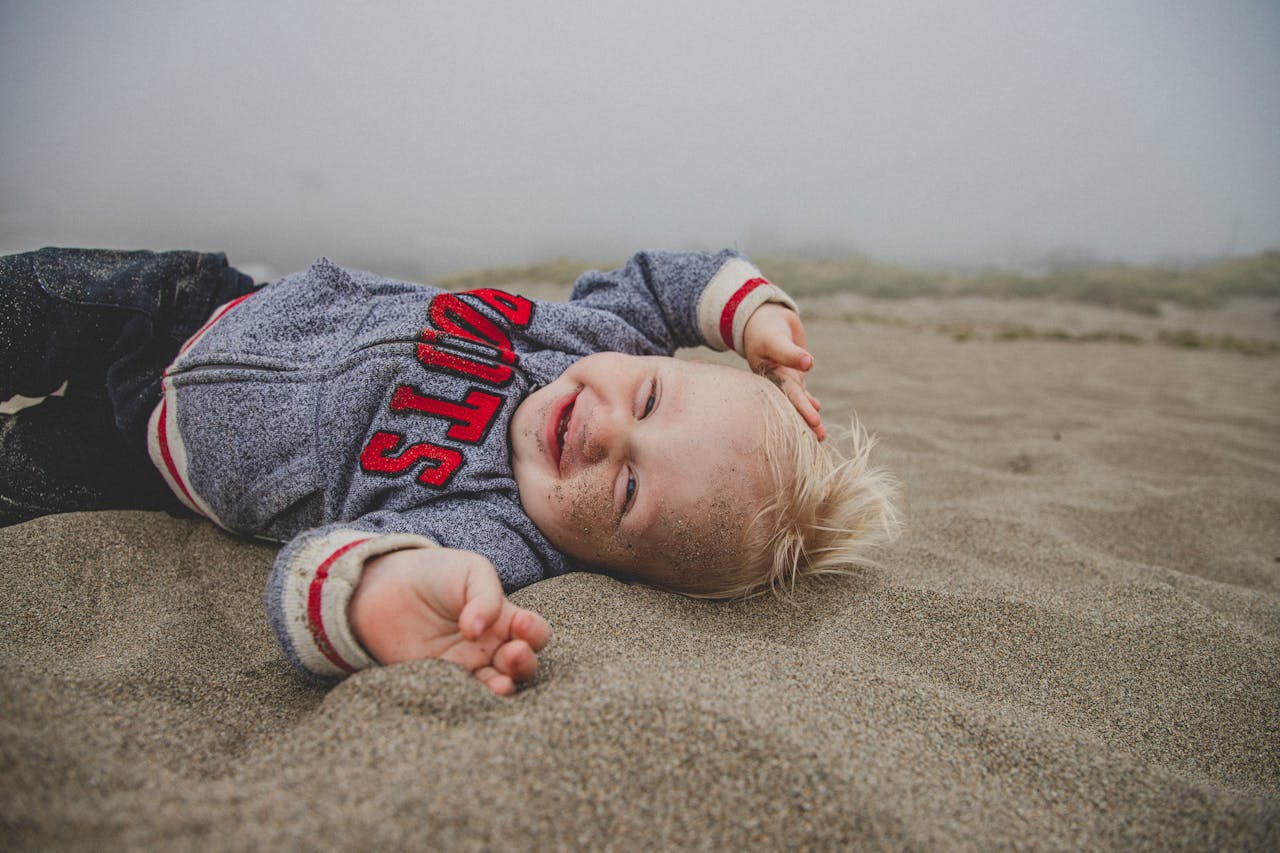 baby playing in sand