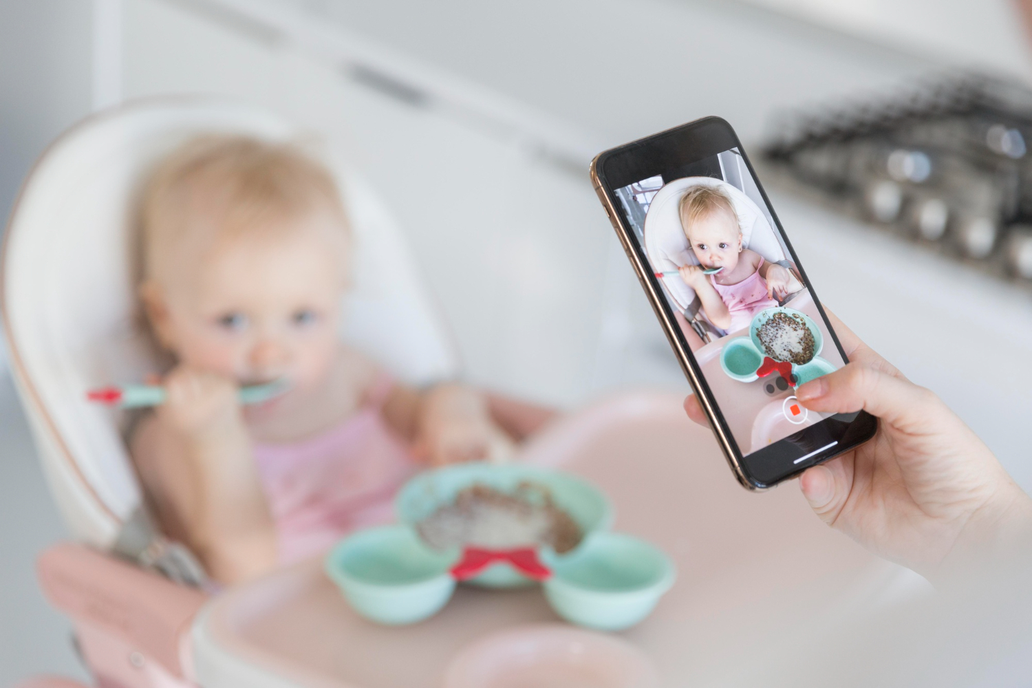 image of a baby's picture being taken with a phone