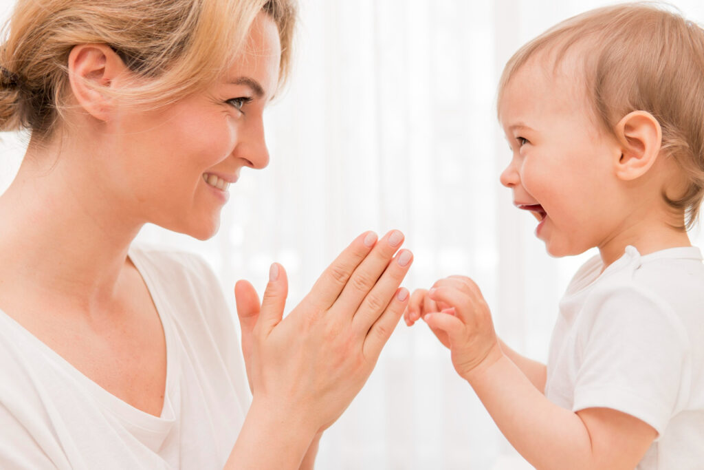a mother and a baby smiling at each other