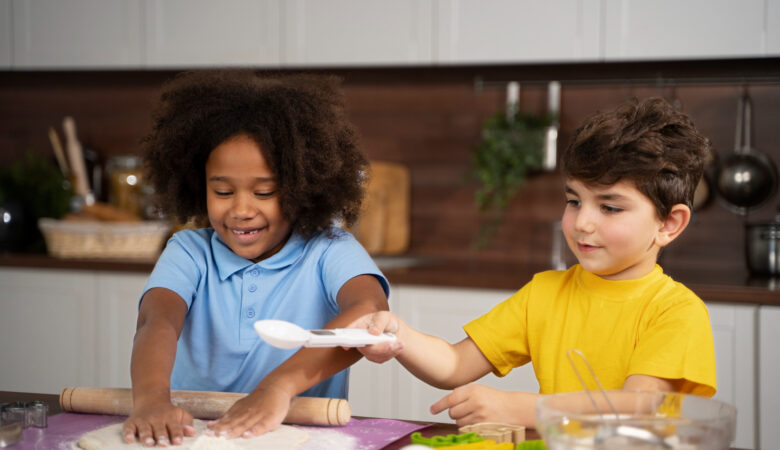 two kids using flour in the kitchen