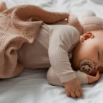 an infant sleeping with a pacifier