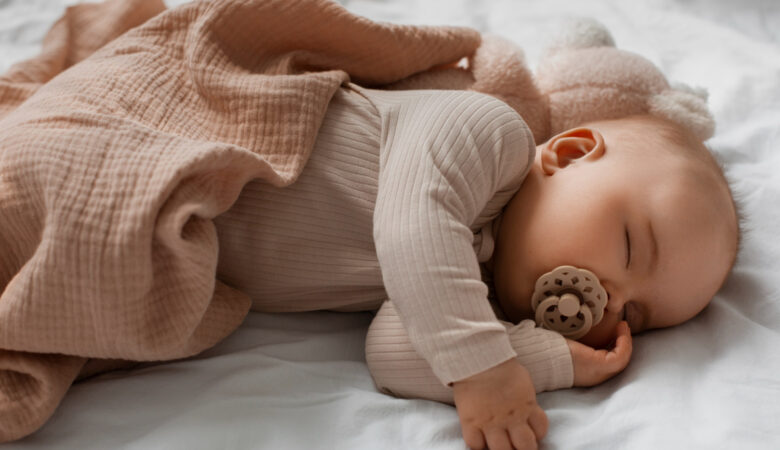 an infant sleeping with a pacifier