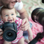 image of a baby holding a camera