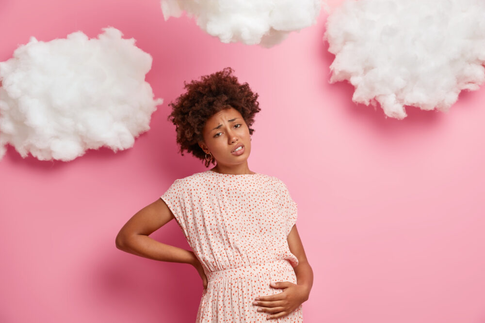 a pregnant lady holding her stomach