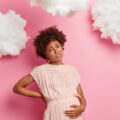 a pregnant lady holding her stomach