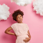 a pregnant lady holding her stomach
