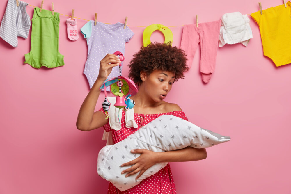 Image of a mom holding a baby hanger and a baby