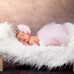 image of an infant baby girl lying in a little fluffy bed