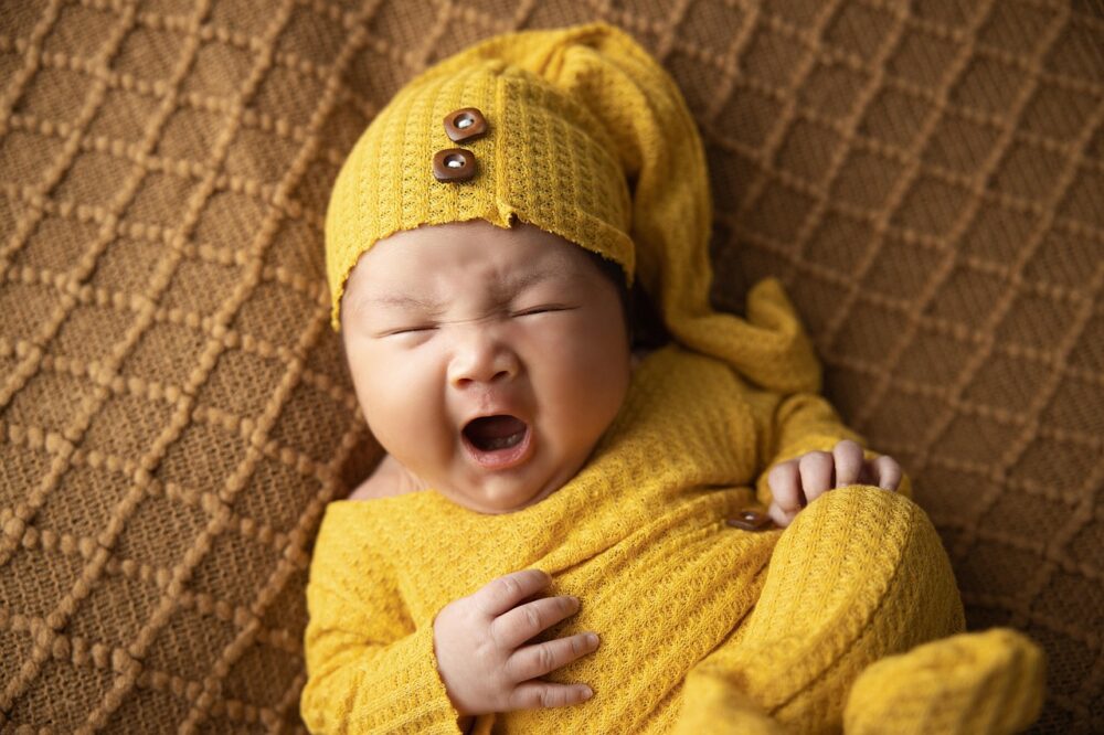 a sleepy baby yawning