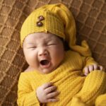 a sleepy baby yawning
