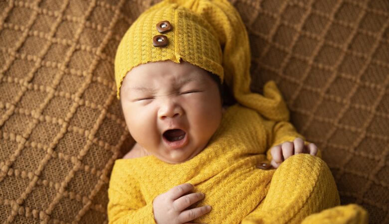 a sleepy baby yawning