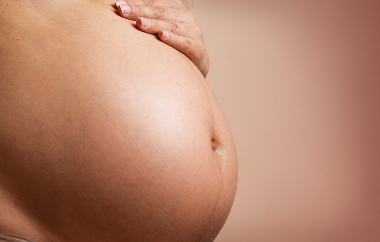 pregnant woman stomach with drak line