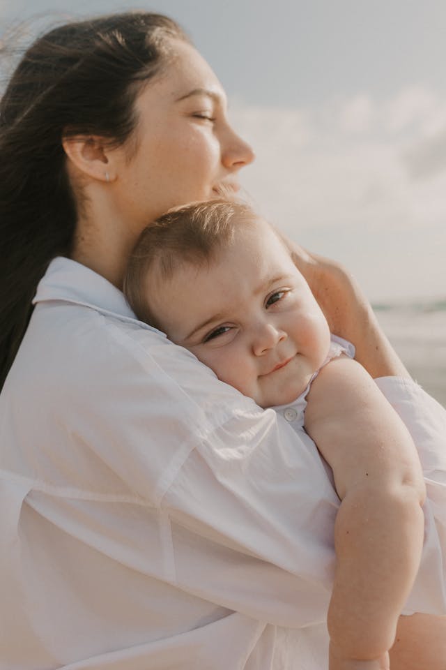 a mom hugging her baby