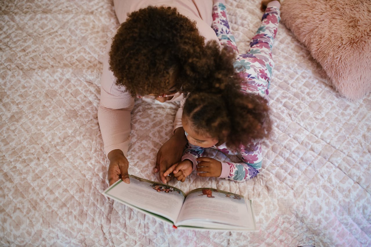 mom and daughter in bed reading bedtime stories